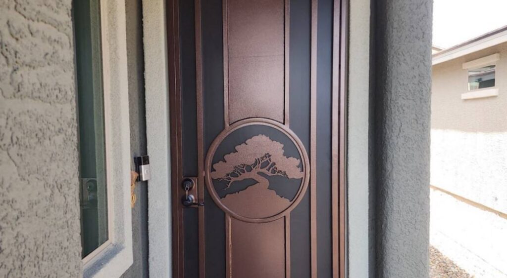 Beautiful bronze colored plasma cut screen door with a circle and tree design in the middle of the door.