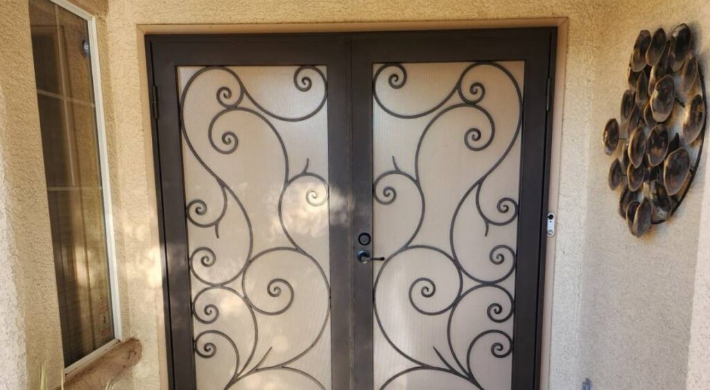 Wrought Iron swirls on cream background, French security door.