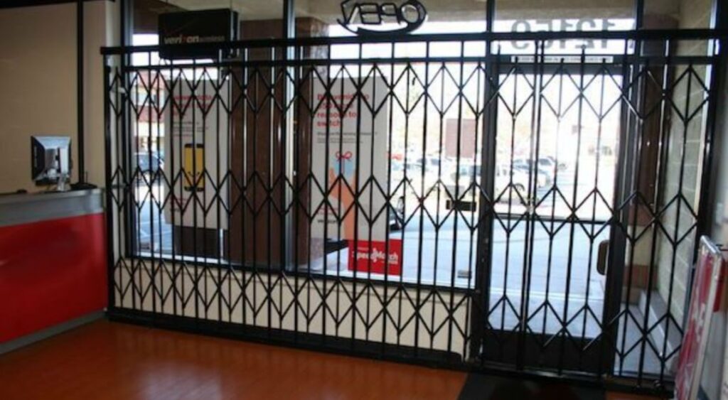 A Scissor Gate Blocking The Entrance Of A Closed Business Ensuring Security