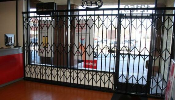 A Scissor Gate Blocking The Entrance Of A Closed Business Ensuring Security