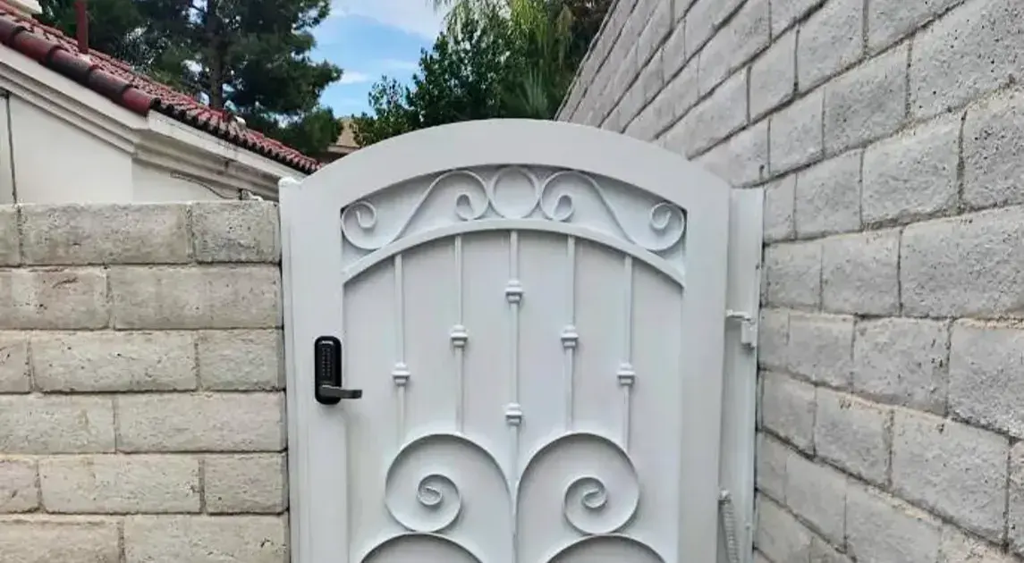 White locking wrought iron side gate.