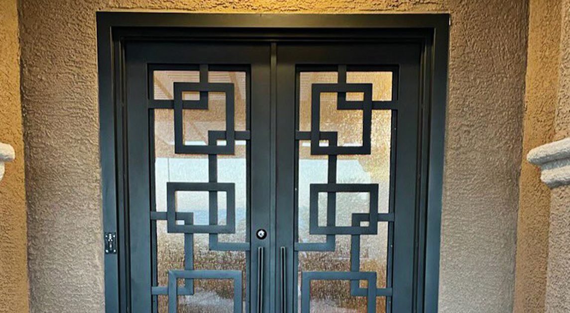 Black, geometric, wrought-iron front door on a Las Vegas property.